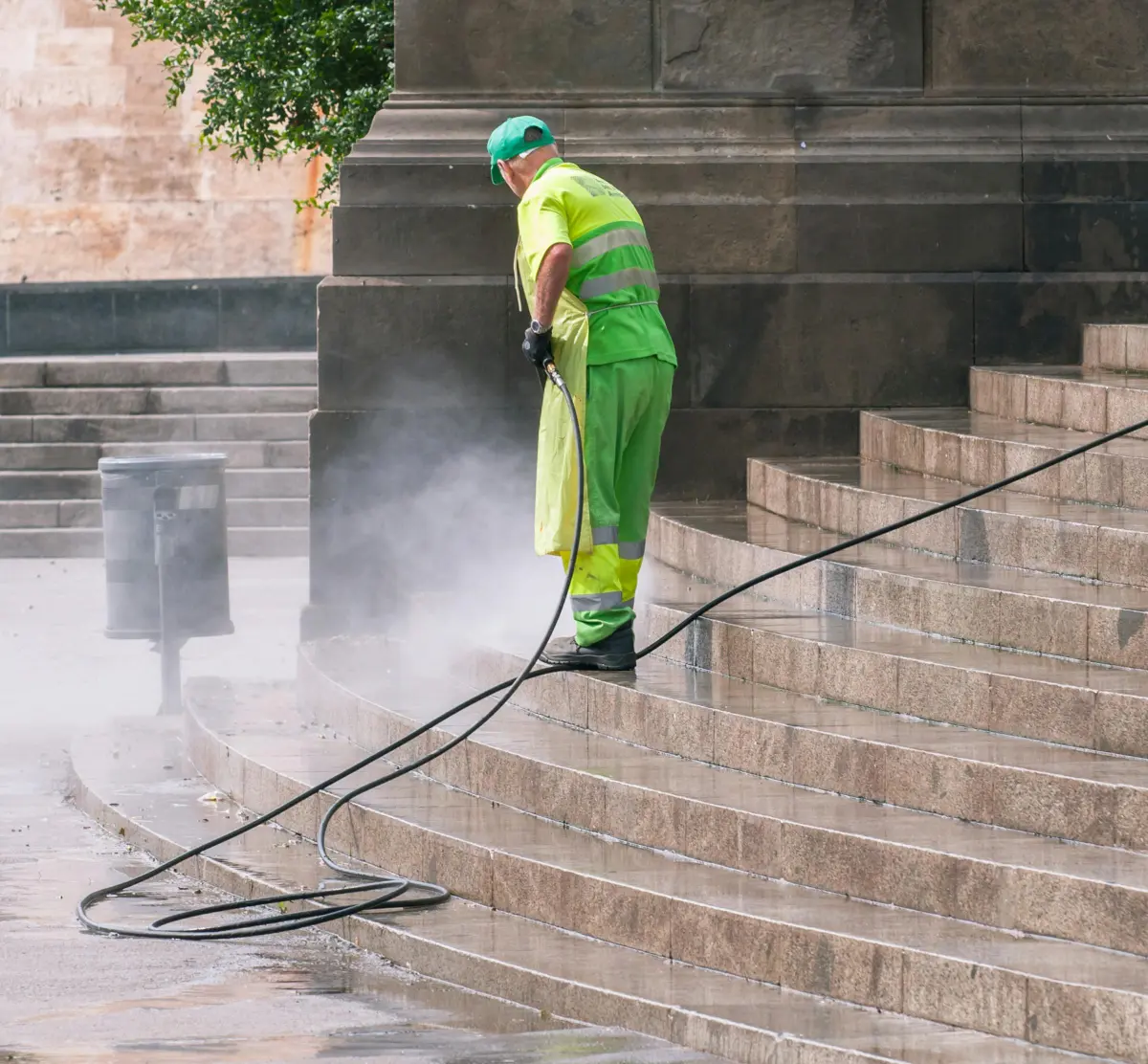 High-pressure water spray clearing a hard surface